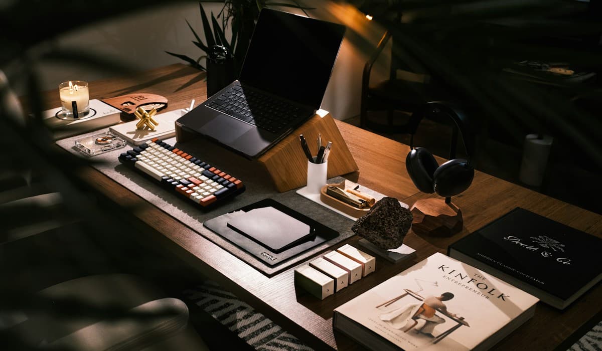 Laptop open on a desk in a warm, well-lit workspace