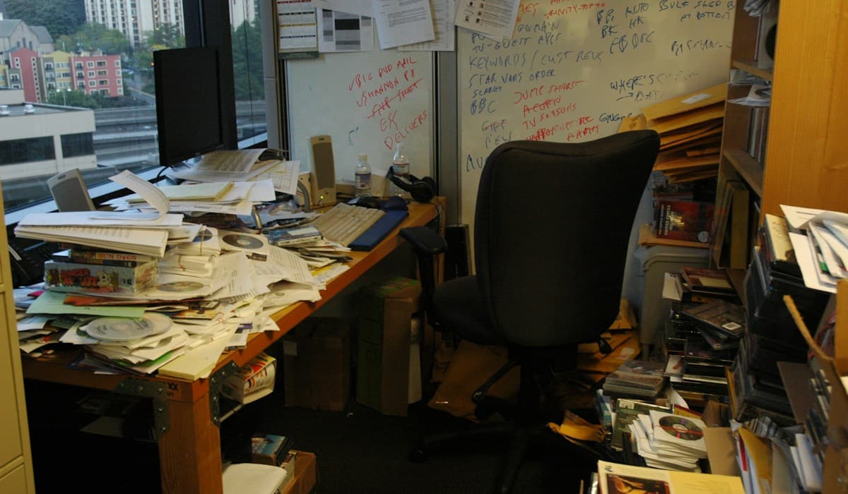 Office table with a pile of stacked papers